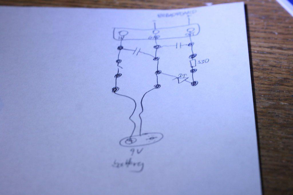 Hand-drawn sketch: 9V battery circuit, phone photo
